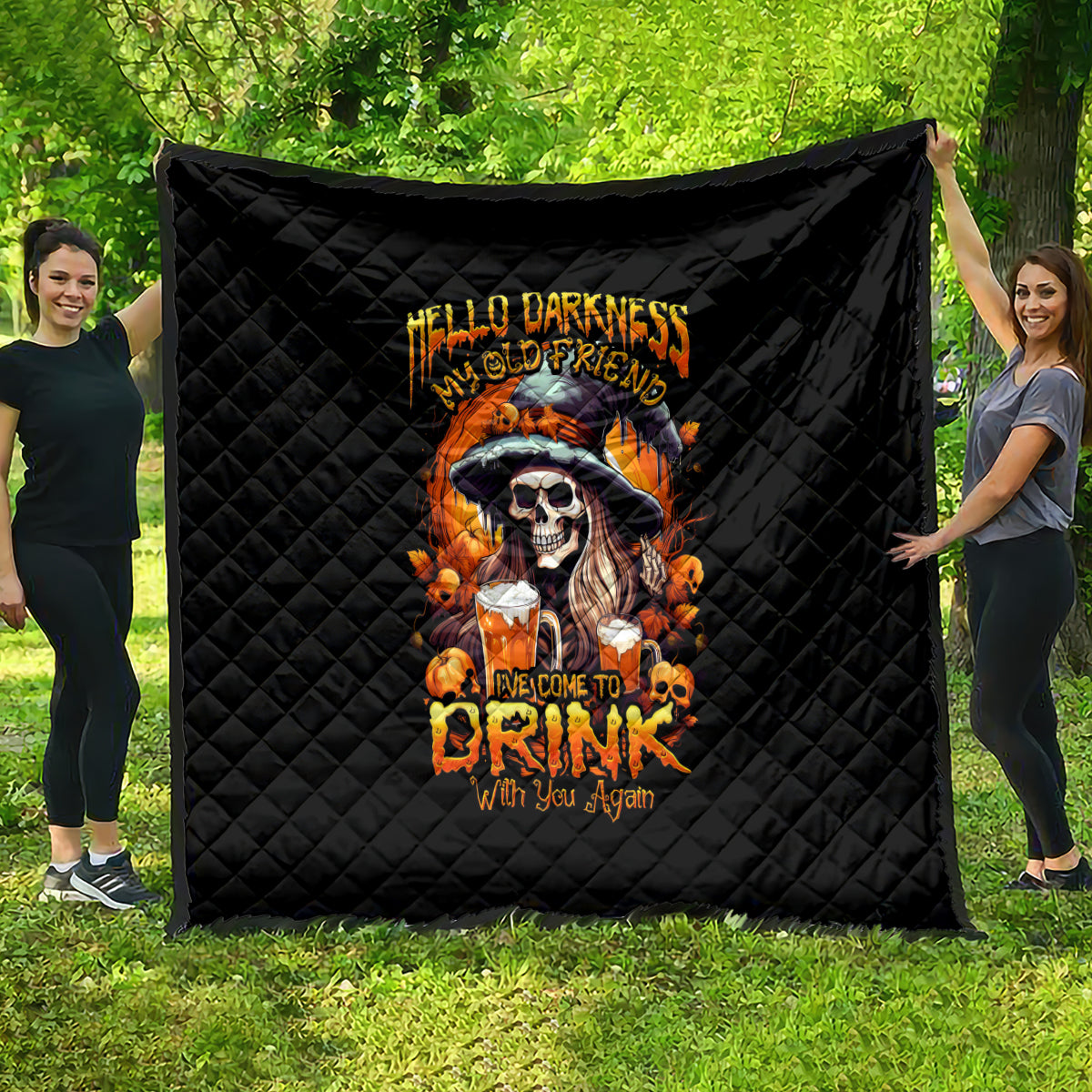 Black quilt with diamond stitching and orange skull artwork, full blanket display.