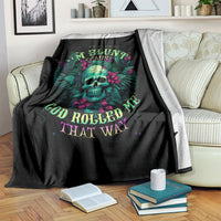 Black skull throw blanket with colorful slogan text, folded and draped over sofa