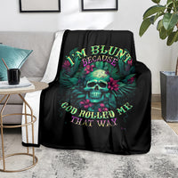 Black skull graphic blanket with bright lettering design, laid over a grey chair