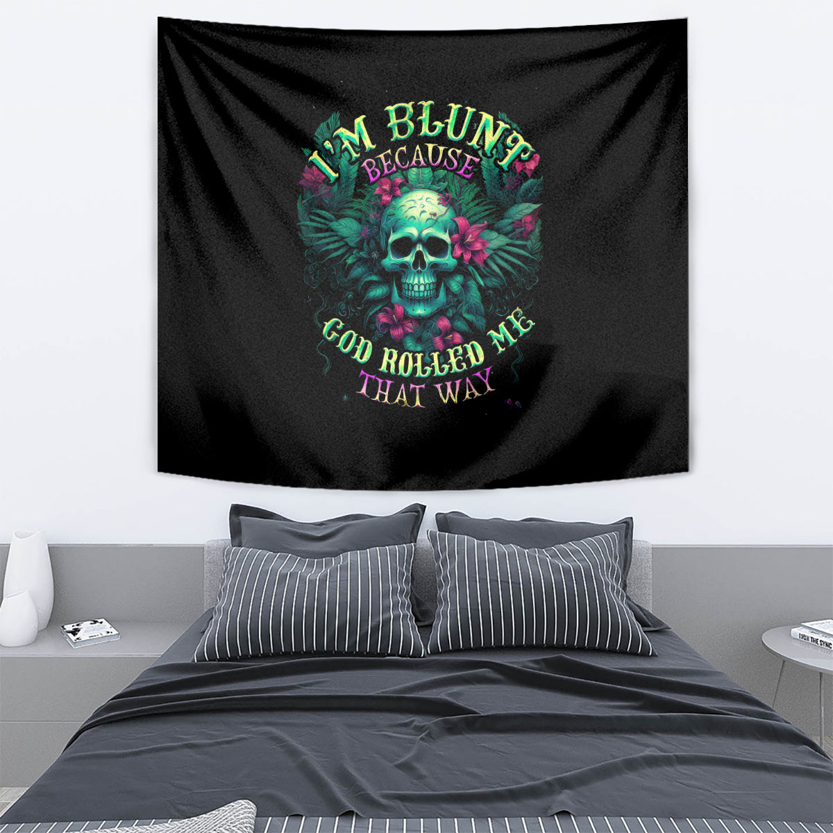 Black wall tapestry with teal skull, pink flowers, and arched colorful text