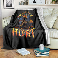 Black blanket draped on couch with flaming skull graphic and distressed lettering