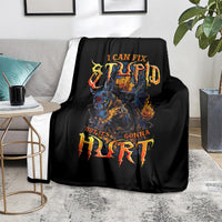 Black throw blanket showing fiery skull graphic with distressed text design