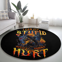 Round black area rug featuring a large fiery skull and multicolor orange-yellow phrase