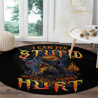 Round black area rug with flaming skull artwork and red-orange lettering, angled view