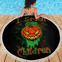Round black beach blanket with fringed edge, jack-o'-lantern skull graphic on full view