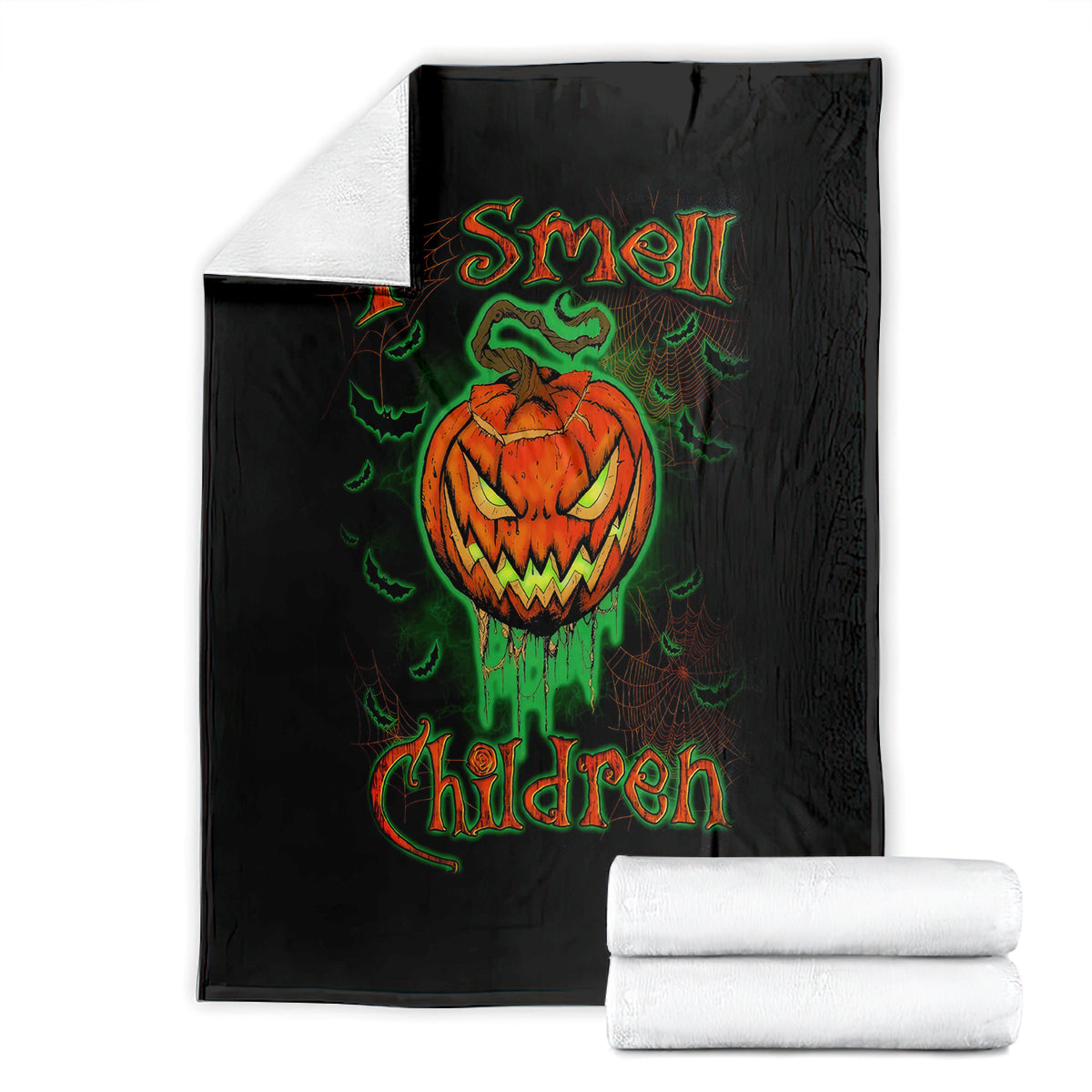 Black Halloween blanket with jack-o’-lantern skull graphic, folded with white towels