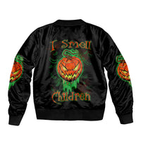 Black bomber jacket with green and orange jack-o-lantern skull graphic on back
