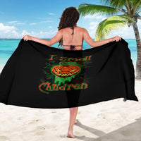 Black jack-o’-lantern skull sarong held open, featuring green orange graphic