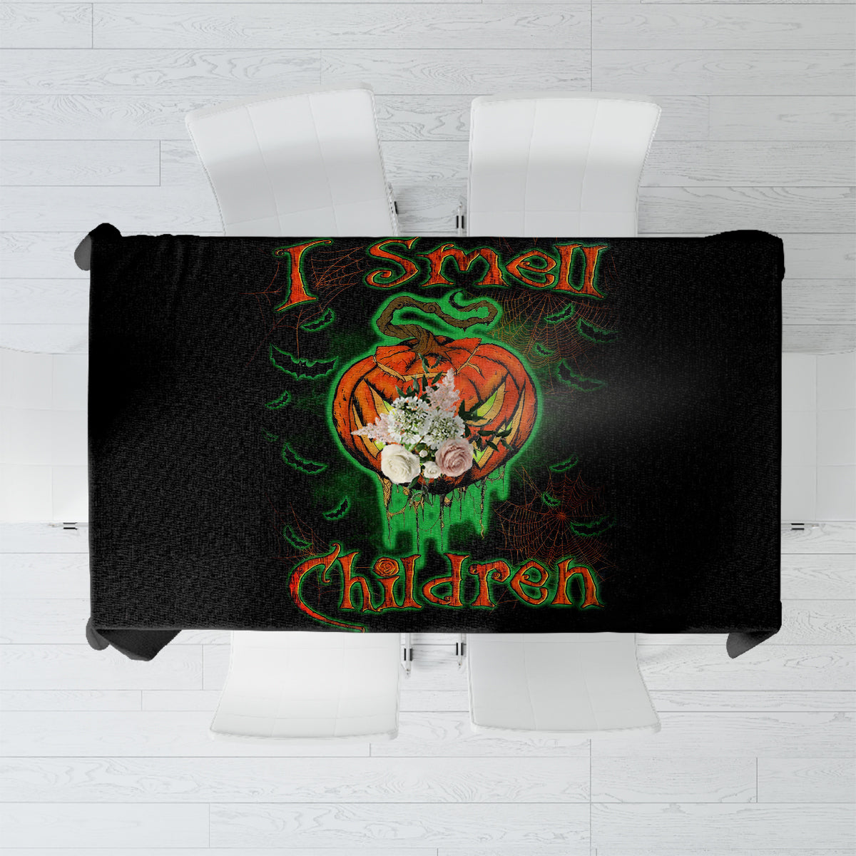 Black tablecloth with jack-o’-lantern skull artwork and readable “I smell children” text