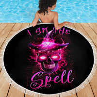 Round black beach blanket with purple skull graphic and 'Spell' lettering, fringed edge.