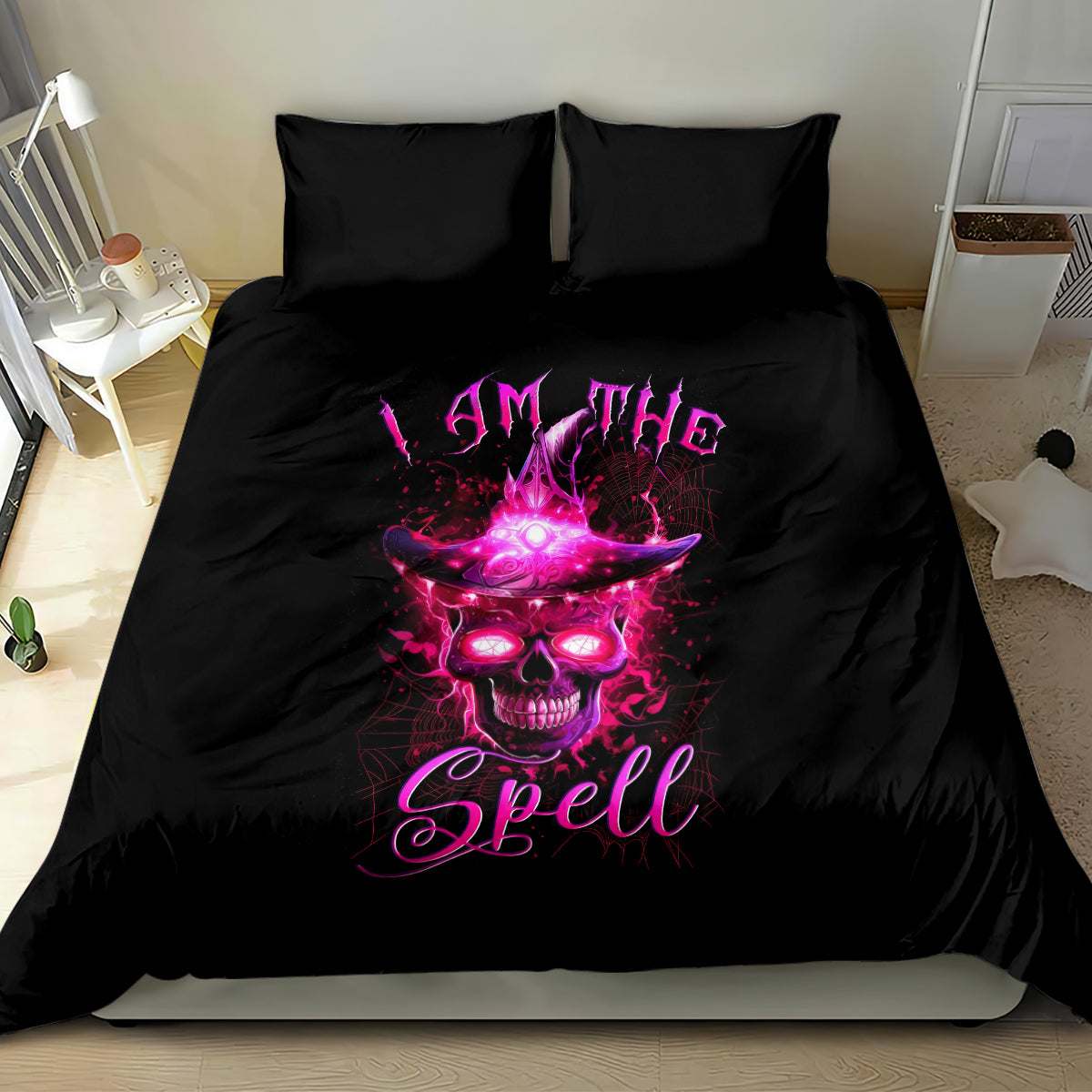 Black bedding set with witch skull and spell text graphic on a bed with two pillows