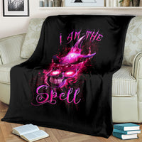 Black throw blanket with purple witch skull and 'Spell' text, draped on sofa