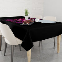 Black tablecloth on dining table with purple witch skull graphic along the edge