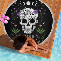 Black round beach blanket with cat skull illustration, fringe trim edge