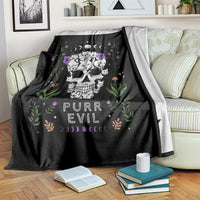 Black cat skull blanket on couch, featuring cats, flowers, moons, and 'PURR EVIL' text