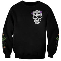 Black unisex sweatshirt with small cat skull graphic on chest and sleeve floral accents