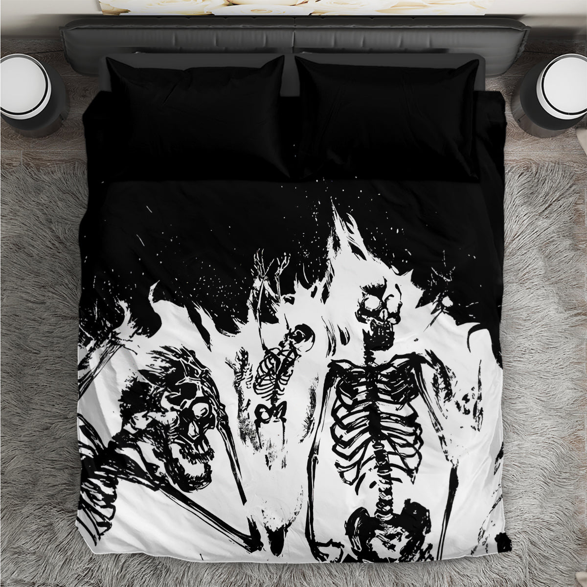 Skull-themed bedding set with black and white skeleton print, laid flat with two pillowcases.