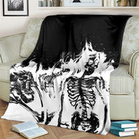 Skull skeleton throw blanket draped on sofa, black and white graphic