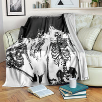 Skull skeleton blanket draped over couch, black and white distressed design