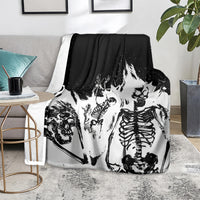 Skull skeleton graphic throw blanket on sofa, black and white distressed art