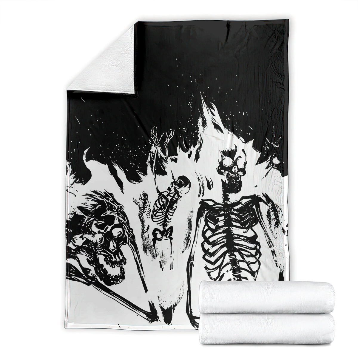 Skull skeleton blanket folded with stacked white towels, black and white print