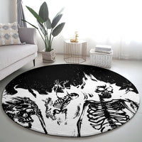 Round graphic area rug with monochrome skull and skeleton artwork