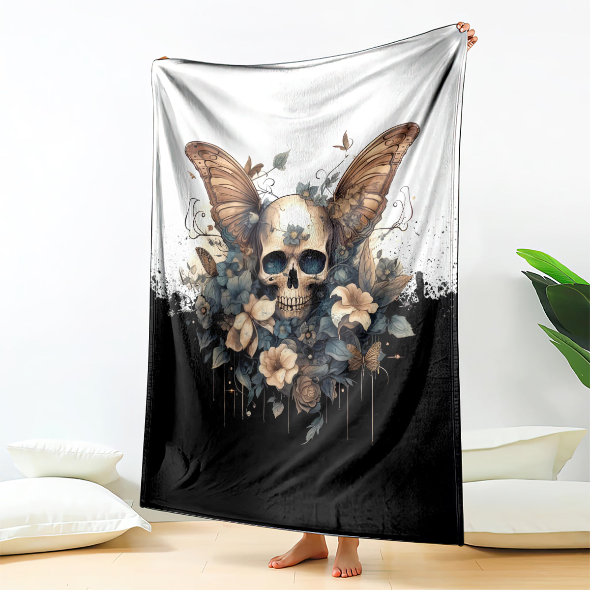 Large gothic skull butterfly blanket draped on bed, black bottom with cream top