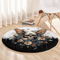 Black round rug on light wood floor with skull, butterflies, and floral print