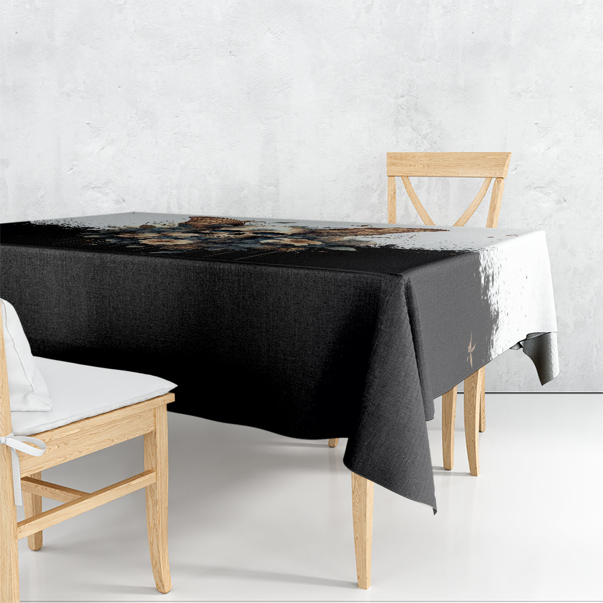 Black gothic skull-and-butterfly tablecloth with floral design, draped over table