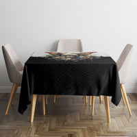 Black skull-and-butterfly tablecloth covering square table with four chairs