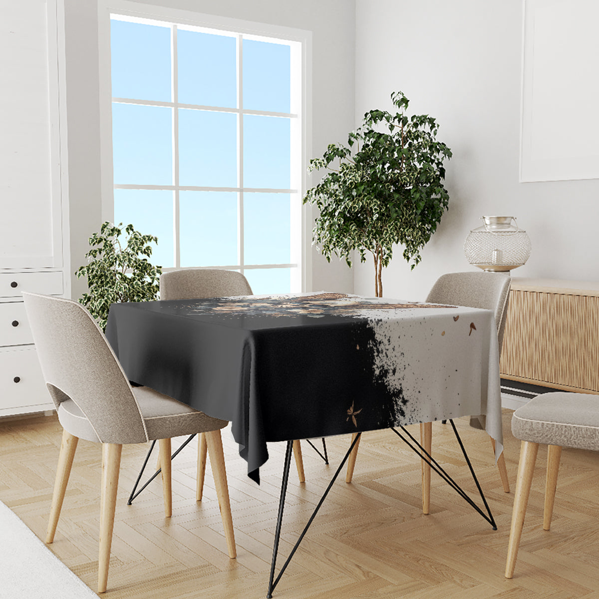 Black gothic tablecloth with butterfly skull graphic and speckled details, dining table set
