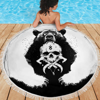 Black-and-white round beach blanket with bear skull cross artwork, fringed trim