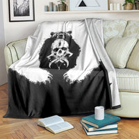 Black and white Viking bear skull throw blanket on striped armchair