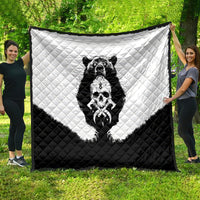 Black and white quilt blanket with quilted texture and bear skull graphic centerpiece