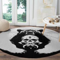Round light-gray rug with black bear skull artwork and dark outer edge