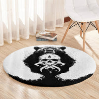 Round rug featuring a bear skull graphic with a black border edge on light fabric
