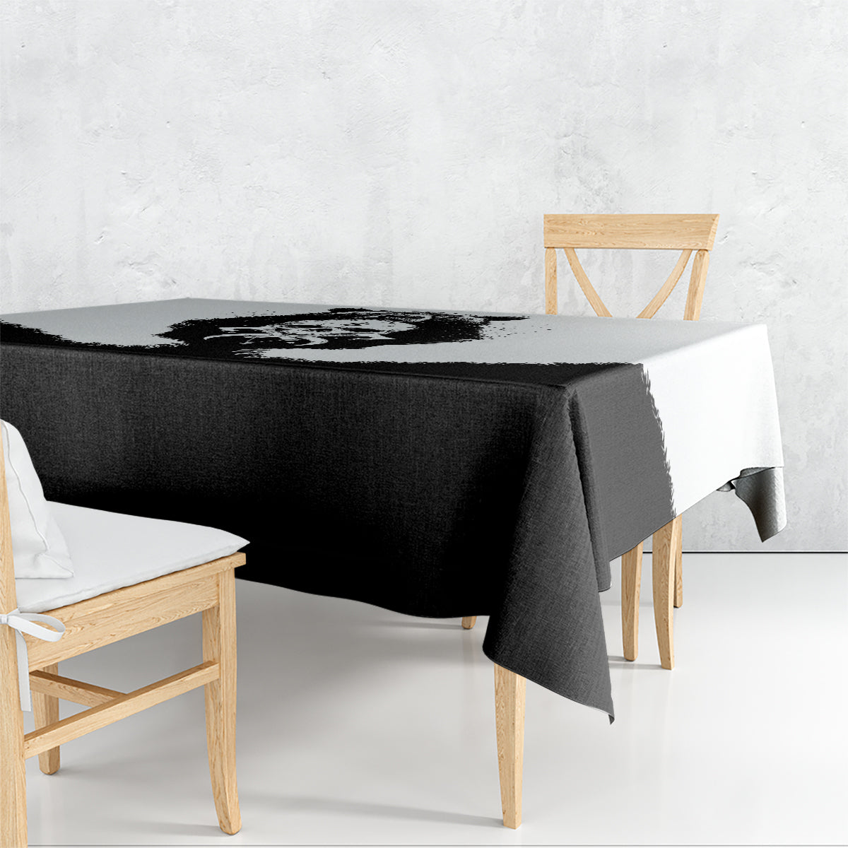 Black tablecloth with draped corner over wooden dining table
