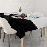 Black tablecloth with bear-themed print across dining table surface