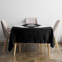 Black tablecloth with central bear graphic on square dining table