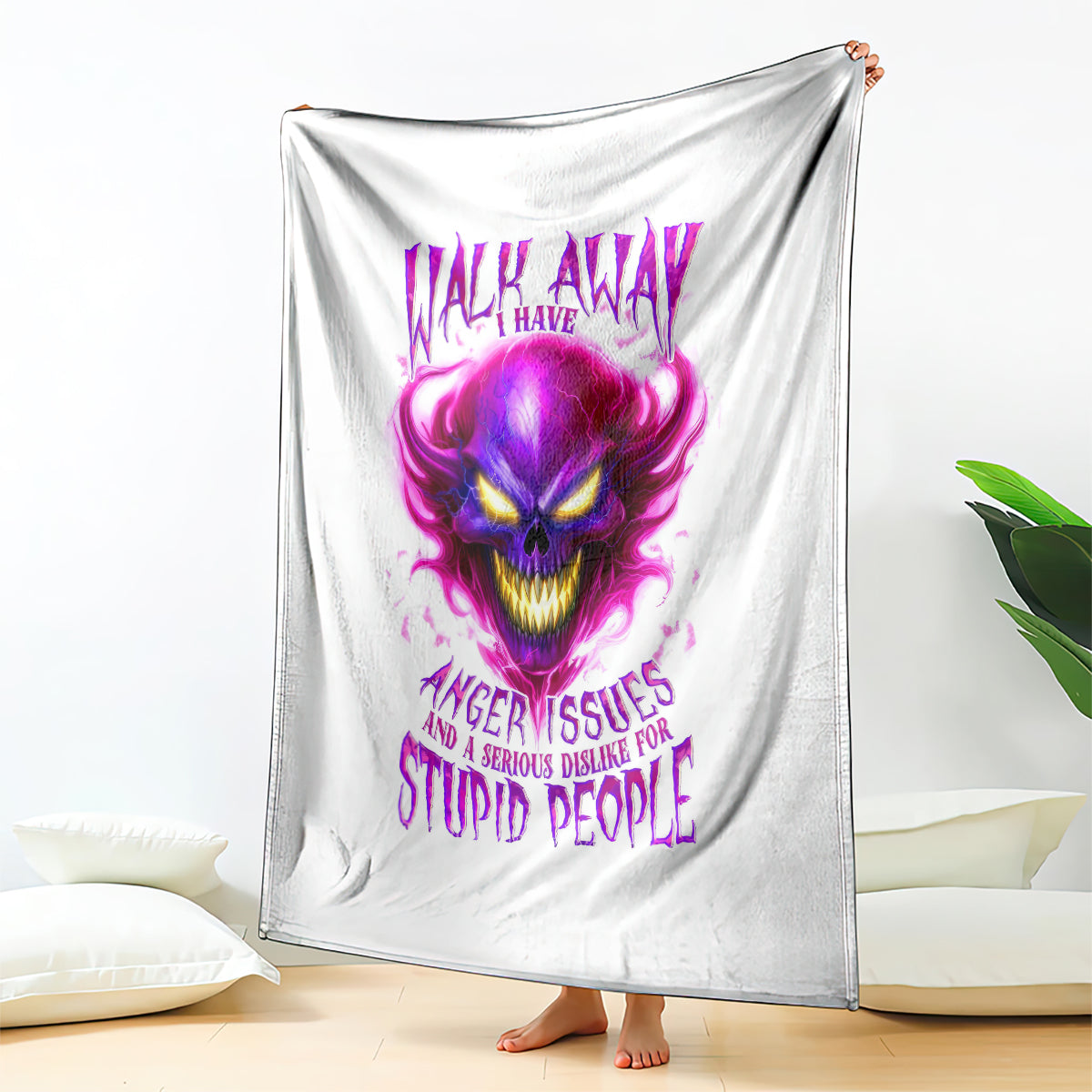 White draped throw blanket with centered purple flame skull graphic and slogan text