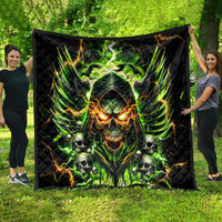 Black skull quilt blanket with glowing green demon face and orange flames, held outdoors.