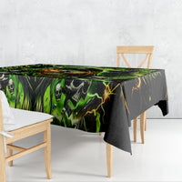 Black skull tablecloth with neon green print, hanging skirt over table corner