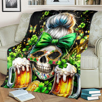 Black blanket with close-up skull face, green bow, clovers, and beer mugs
