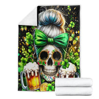 Black skull and shamrock blanket with green bow and beer mugs, folded with white towels