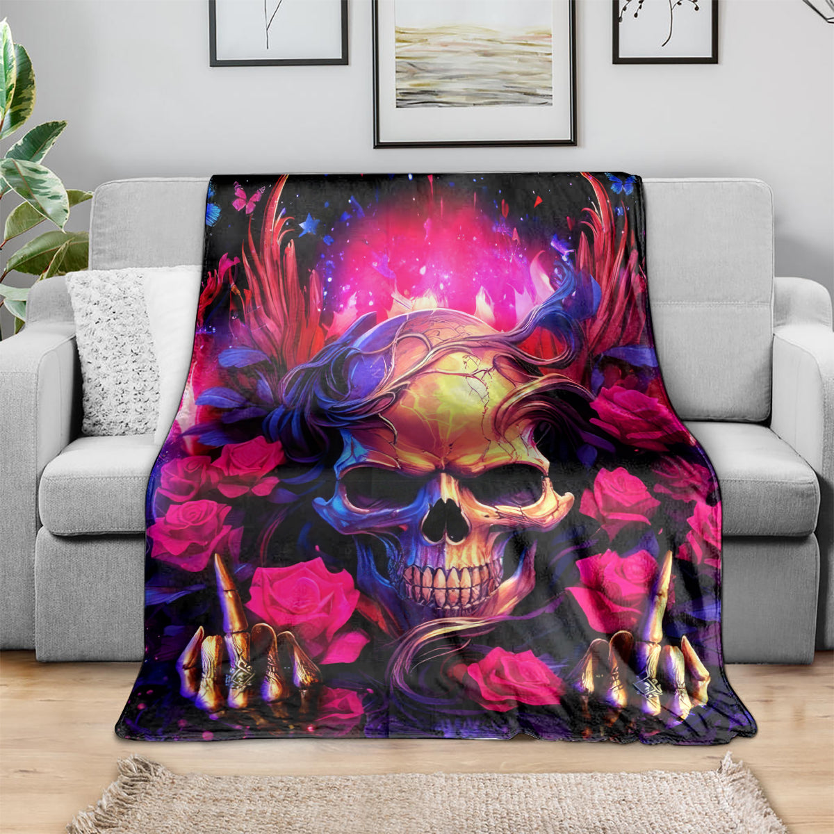 Skull rose blanket spread on couch, glowing skull face with pink roses and dark blue accents