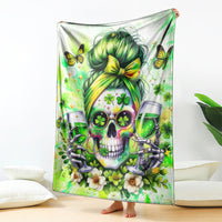 Green skull blanket with clovers, butterflies, and wine glasses, draped over the floor
