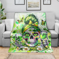 Green skull blanket spread on a sofa, featuring a green-haired skull and clover details