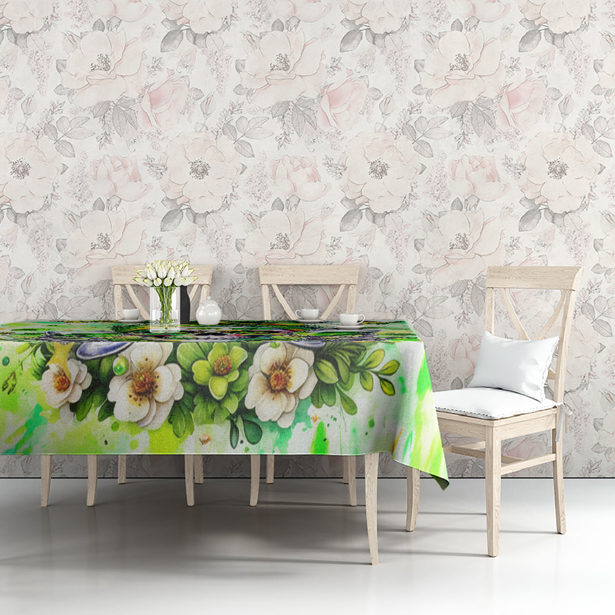 Green tablecloth with floral leaves pattern, on dining table between light chairs