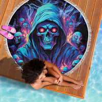 Round skull beach blanket with teal hooded reaper skull, glowing eyes, colorful flames, held open