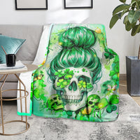 Green skull throw blanket with teal-haired girl, clovers and gold coins, on couch